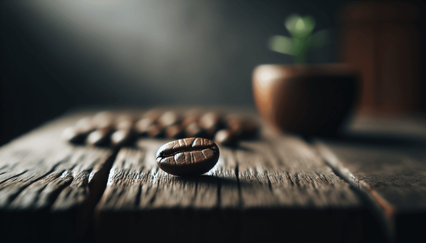 A single, richly brown coffee bean with visible texture details sits on a rustic wooden table, illuminated by soft, natural light. In the background,